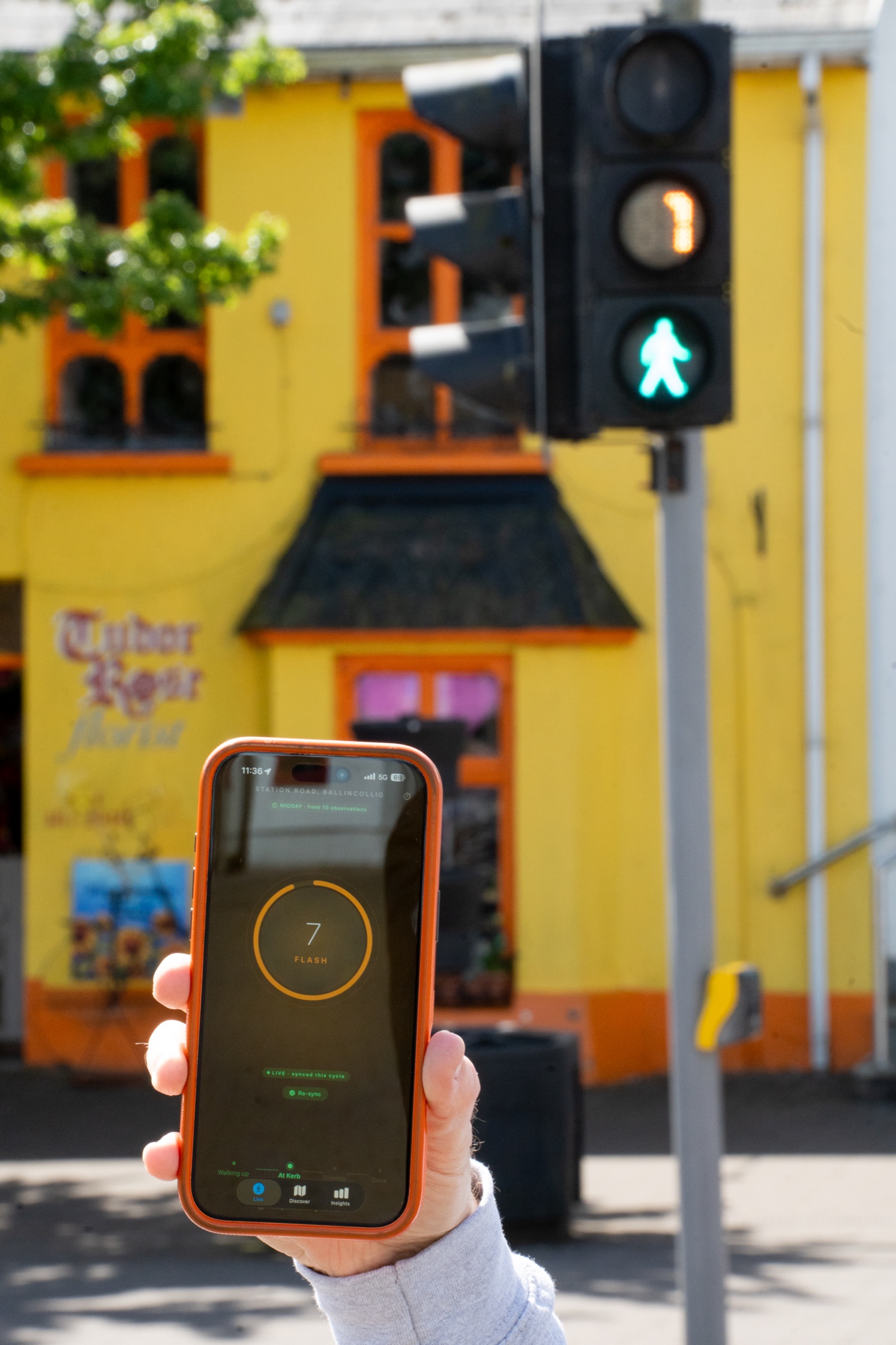 WalkPhase running on iPhone at a signalised pedestrian crossing in Ballincollig, Cork — countdown of 7 seconds matches the live walk phase